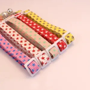 Detailed close-up shot of colorful pet collars featuring cute star patterns, with buckles and bells.