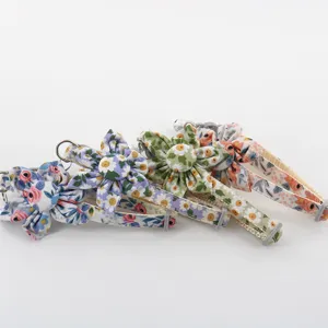 Close-up detail of cute floral pet collars with fabric daisy flower decorations for cats dogs.