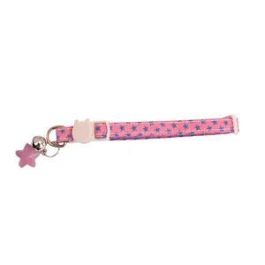 Close-up of pink star cat collar with cute bell, cat buckle, and sparkling star pendant.