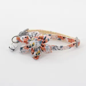 Close-up of pet floral cat collar with fabric flower and bell, cute neck accessory detail.