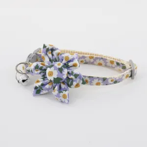 Detailed view of a cute floral pet cat collar with a sweet daisy flower and a small bell.