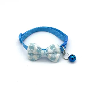 Close-up of blue plaid pet collar showcasing the cute bowknot and metal bell accessory.