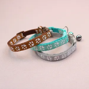 Detailed view of cute pet collars with paw prints and bells, ideal for small dogs and cats.