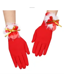 Detail shot of Christmas red plush gloves with bow and bell for women holiday accessory