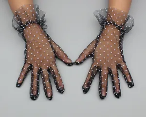 Detail view of black mesh polka dot short gloves with cute ruffles for women stylish party.