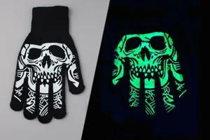 Close-up detail of black knit skeleton gloves showing day and night glowing skull pattern.