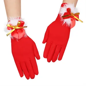 Red Christmas gloves for women with white plush trim and cute bow bells for holiday party wear.