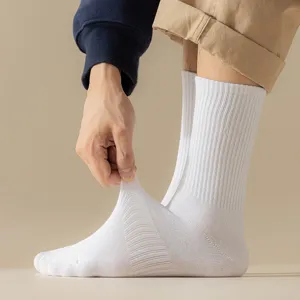 Close-up of white ribbed athletic socks showing high elasticity and soft cotton material.