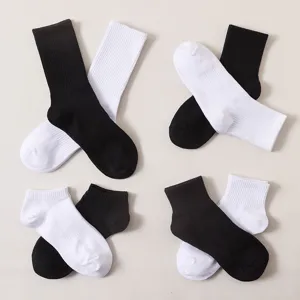 Detailed view of black and white cotton socks set, showing fabric texture and neat pairing.