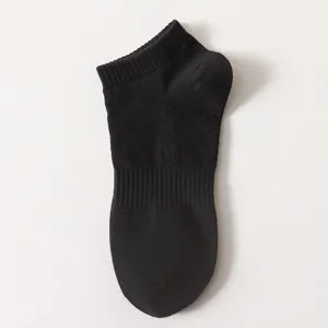 Close-up detail of black ankle socks, soft knitted fabric texture, simple daily wear.