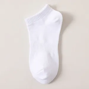 Detailed shot of a clean white low cut ankle sock featuring breathable ribbed cuffs.