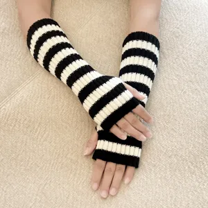 Black and white striped knitted fingerless arm warmers, cozy mid-length sleeve gloves.