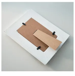 Detailed view of the wooden picture frame back showing the sturdy easel stand and clips.