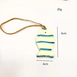 Mediterranean style wooden fish pendant hanging ornament for home wall decor and coastal room.
