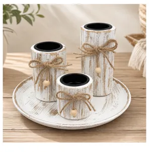 Close-up detail of rustic distressed wooden candle holders set with jute rope bows.