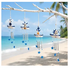 Detail shot of Mediterranean sailboat wind chime with blue stars and metal tubes for seaside decor.