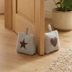 Fabric door stop with star and heart patch, decorative heavy door wedge for home use.