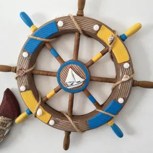 Mediterranean wooden ship wheel wall decor, vintage nautical hanging ornament with sailboat.