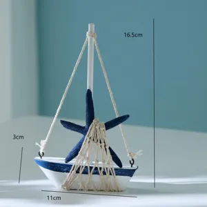 Detail view of miniature wooden sailboat with blue starfish and rope net, perfect desktop decor.