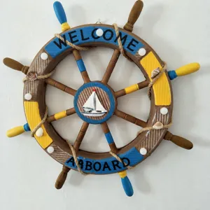 Nautical wooden ship wheel wall decor with hemp rope and sailboat detail for home.