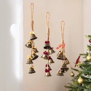 Vintage Christmas hanging metal bells with jute rope and bows for rustic holiday party decor
