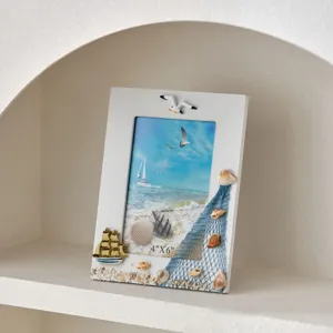 Mediterranean style 6-inch wooden photo frame with seashells, nautical sailboat and seagull.
