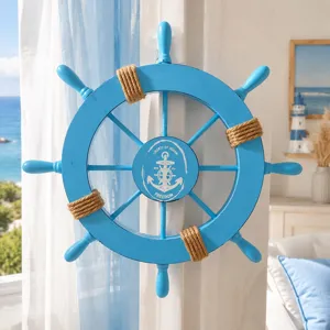 Coastal blue wooden ship's wheel wall hanging with rustic hemp rope and ocean text details.