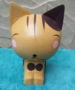 Handcrafted wooden cat figurine detail, perfect cute desktop ornament and home decor gift.