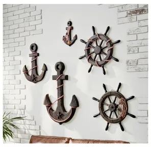 Mediterranean nautical wall decor set including wooden anchor and ship wheel for home styling.