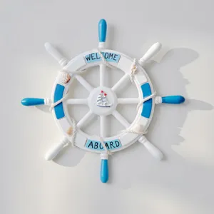 Mediterranean style wooden ship wheel wall hanging detail, nautical decor with rope and shells.
