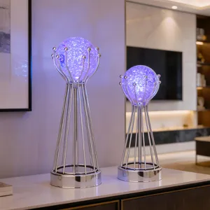 Modern luxury glowing crystal ball decorative lamp with metal stand for living room decor.