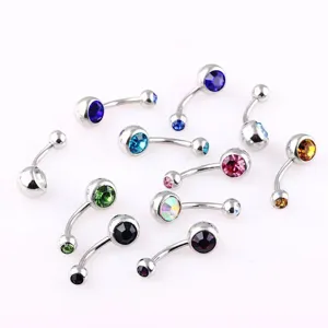 Detailed view of colorful rhinestone stainless steel navel piercing curved barbell body jewelry.