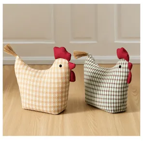 Detail view of fabric chicken doorstop ornament with plaid pattern and sand filling.