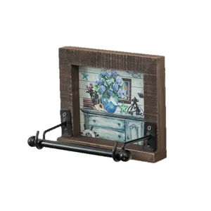 Vintage wall-mounted wooden toilet paper holder with decorative print and black metal bracket.
