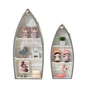 Mediterranean style wooden boat shelf set with cute dolls and nautical theme desktop decor for home.