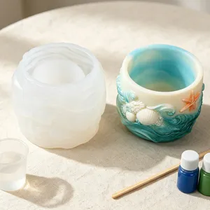 Detail view of ocean wave silicone mold and finished resin pot with pigment and tools.