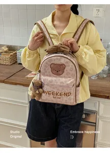 Cute Japanese style small girl backpack with bear patch and plush pendant for daily travel.