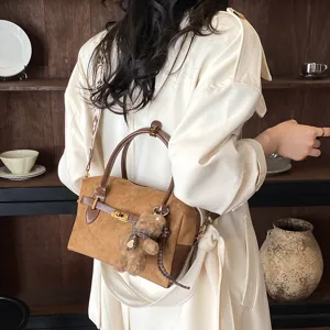 Modische braune Wildleder Boston Handtasche mit Metallverschluss und Bär Anhänger.