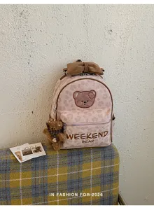 Cute pink leopard print mini backpack detail with adorable bear patch, perfect for daily style.