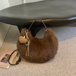 Brown plush hobo shoulder bag with fuzzy texture, knitted heart pendant, stylish autumn detail.