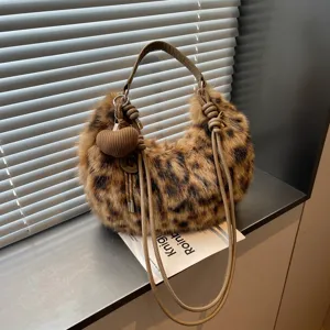 Stylish leopard print plush shoulder bag for women, cozy faux fur hobo handbag with cute charm.