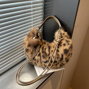 Chic leopard print plush shoulder bag with brown leather strap and cute heart pendant for women.