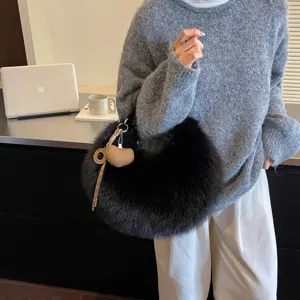 Stylish black faux fur shoulder bag for women, cozy winter fluffy hobo purse with cute charm.