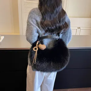 Stylish black plush shoulder bag for women, soft faux fur crossbody handbag with cute charms.