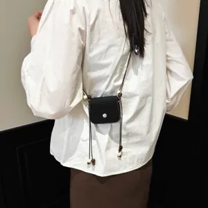 Fashionable minimalist black mini crossbody bag with cute wooden beads string for women.
