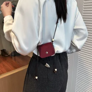 Exquisite mini crossbody bag for women, stylish wine red velvet lipstick bag for outdoor casual wear.