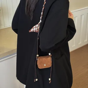 Mini brown suede crossbody bag with patterned strap and wooden bead tassels for women casual