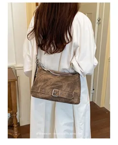 Vintage brown shoulder bag for women, large capacity retro pillow bag with chic belt design.