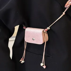 Exquisite mini crossbody bag for women, stylish pink small lipstick pouch with bead strap.
