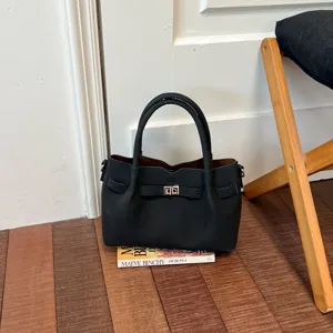 Chic black shoulder bag with metal turn-lock closure, stylish daily crossbody bag for women.
